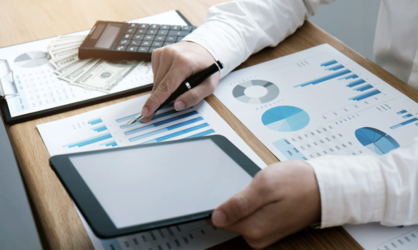 Dashboard-style pages and cash representing how a Managed Services Provider may present polished metrics and account views as part of a sales-driven strategy, rather than offering true strategic partnership.